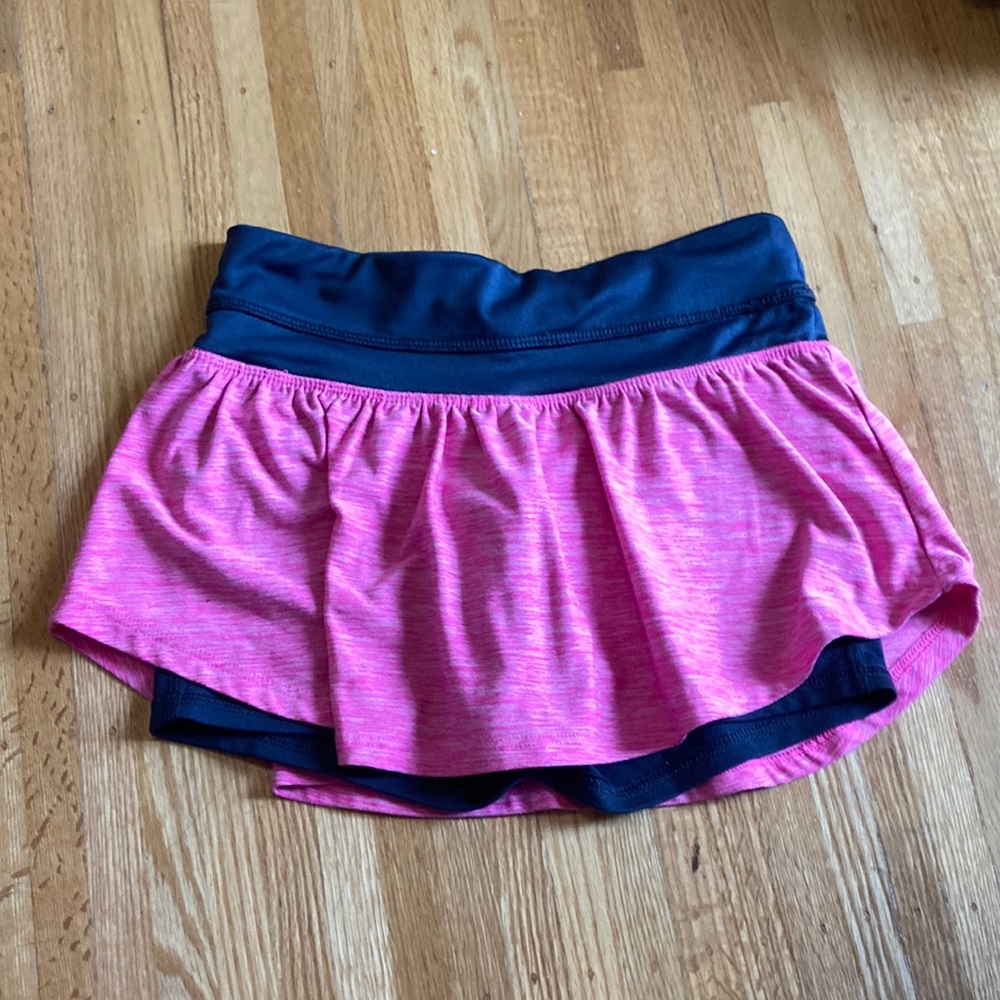 Girls bright pink sport skirt with shorts.